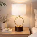 Circular metal table lamp illuminating a cozy Scandinavian-style living room space