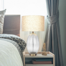 Front view of the Aurora clear ribbed glass table lamp in an elegant living room