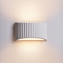Front view of the French-style vintage natural plaster bedside wall sconce mounted on a textured plaster wall