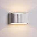 Elegant 22cm plaster wall lamp illuminating a cozy French country bedroom headboard