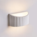 Close-up detail of the smooth matte white natural plaster texture and organic curves