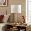 Close-up detail of the transparent glass body seamlessly meeting the brushed nickel base