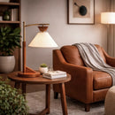 Front view of a mid-century modern brown solid wood desk lamp in a stylish home office