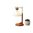 Warm ambient light glowing softly through the cone linen shade in a cozy bedroom