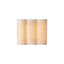Soft, indirect ambient light washing gracefully up and down a textured bedroom wall