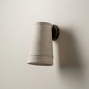 Rustic minimalist wall sconce providing gentle, glare-free accent lighting for a quiet reading nook