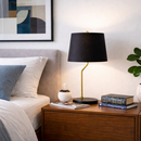 Close-up of the elegant gold accents detailing the matte black metal lamp base