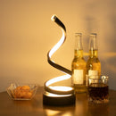 USB power cable connected to a laptop to power the adjustable spiral desk lamp