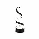 Modern spiral LED desk lamp acting as a chic, space-saving bedside nightstand light