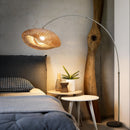 Front view of a modern button-controlled fishing floor lamp with LED lighting in a spacious living room