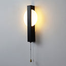 Studio product photography of the black and white wall lamp against a seamless white background