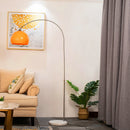Front view of a modern minimalist stainless steel fishing floor lamp in a contemporary living room