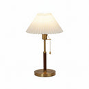 Soft diffused light from the pleated shade creating a serene bedroom atmosphere