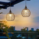 Included remote control for the battery-powered LED chandelier resting on a wooden table