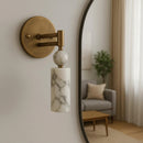 Elegant marble and copper wall lamp illuminating a cozy vintage living room hallway