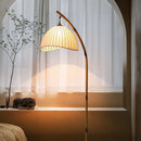 Organic retro floor atmosphere lamp casting a warm and serene glow in a cozy bedroom